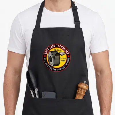 Duct tapes apron - Cartoon duct tape roll in yellow circle with red border and white text reading DUCT TAPE TECHNICIAN — shown on a black cotton canvas apron against a white background