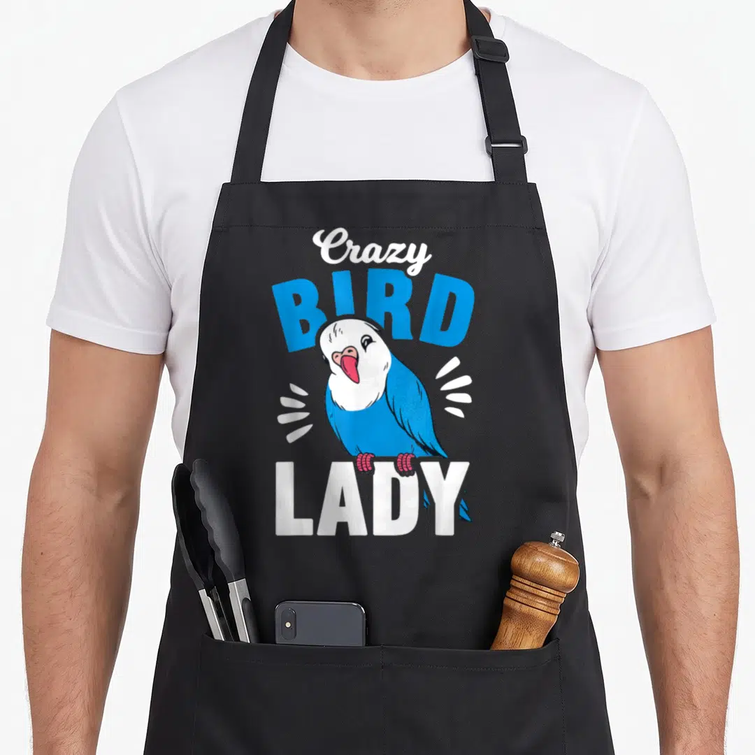 Bird apron for dad - Blue and white cartoon parrot with Crazy Bird Lady text and motion lines — shown on a black cotton canvas apron against a white background