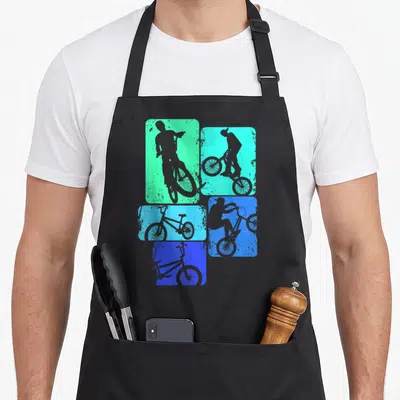 Bmx bicycle bike apron - Five distressed rectangles in green cyan and blue with grey bicycle and rider silhouettes — shown on a black cotton canvas apron against a white background