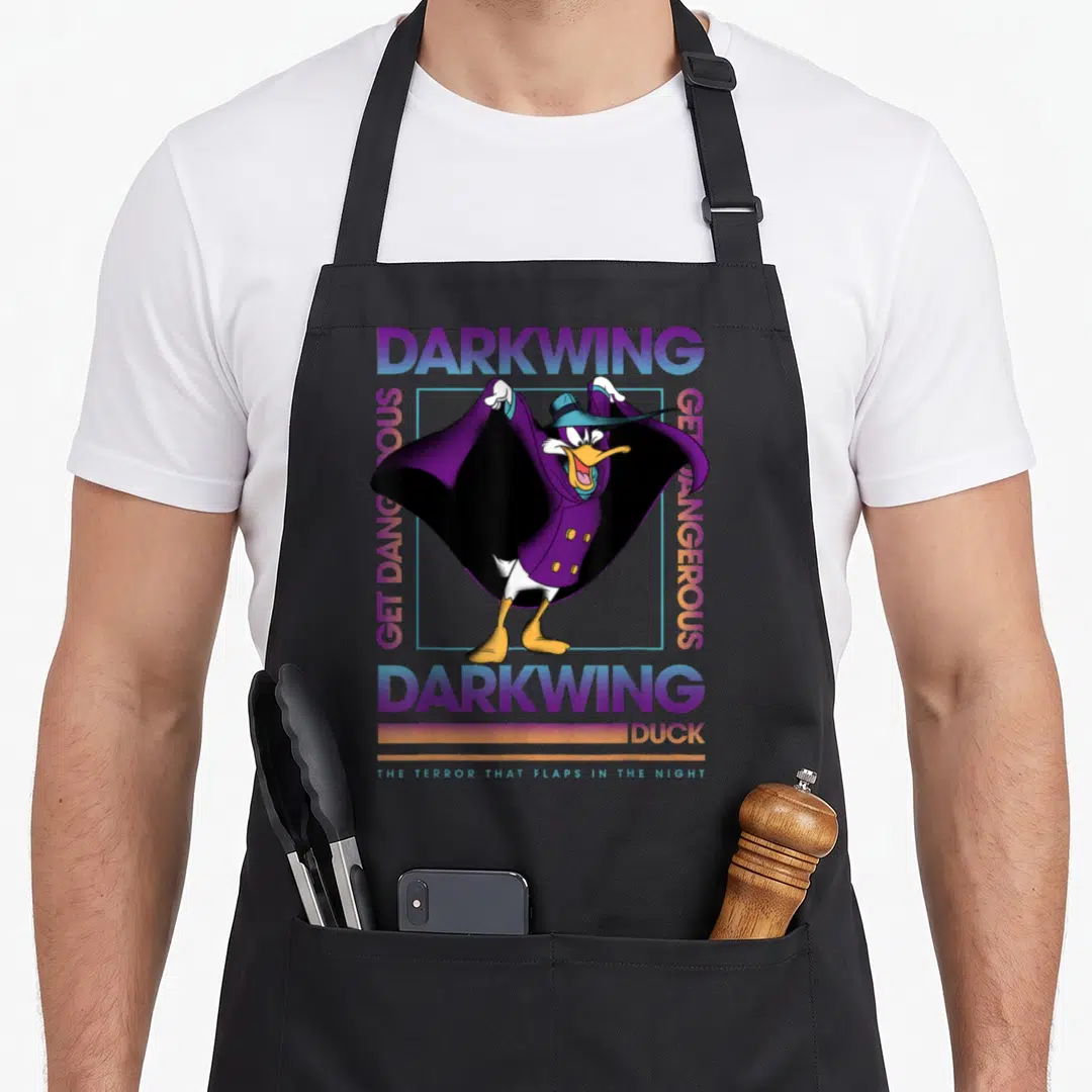 Dangerous duck apron - Darkwing Duck character inside light blue square with Get Dangerous text in purple and orange — shown on a black cotton canvas apron against a white background