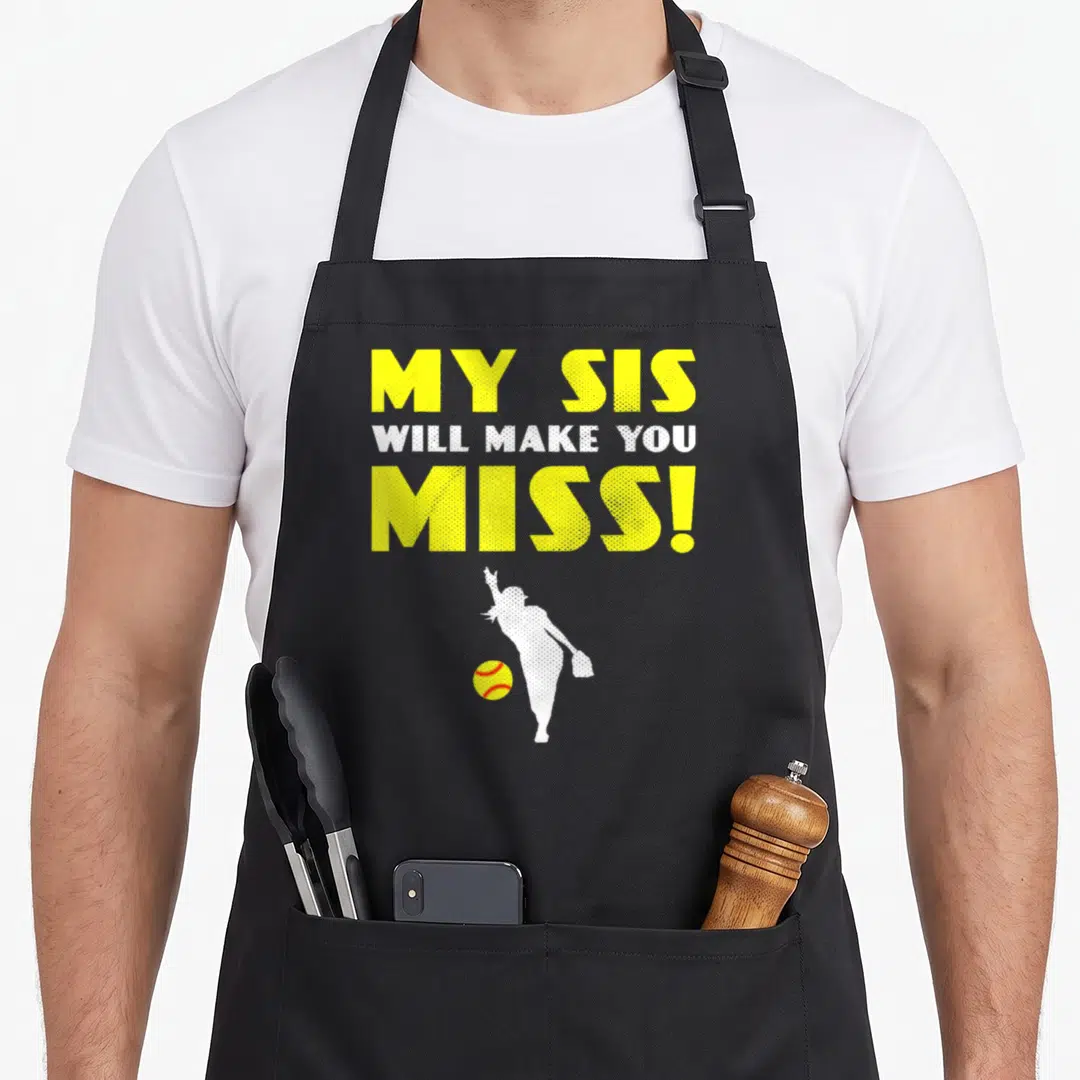 Softball nun apron - Yellow text MY SIS WILL MAKE YOU MISS above white pitcher silhouette and yellow ball — shown on a black cotton canvas apron against a white background