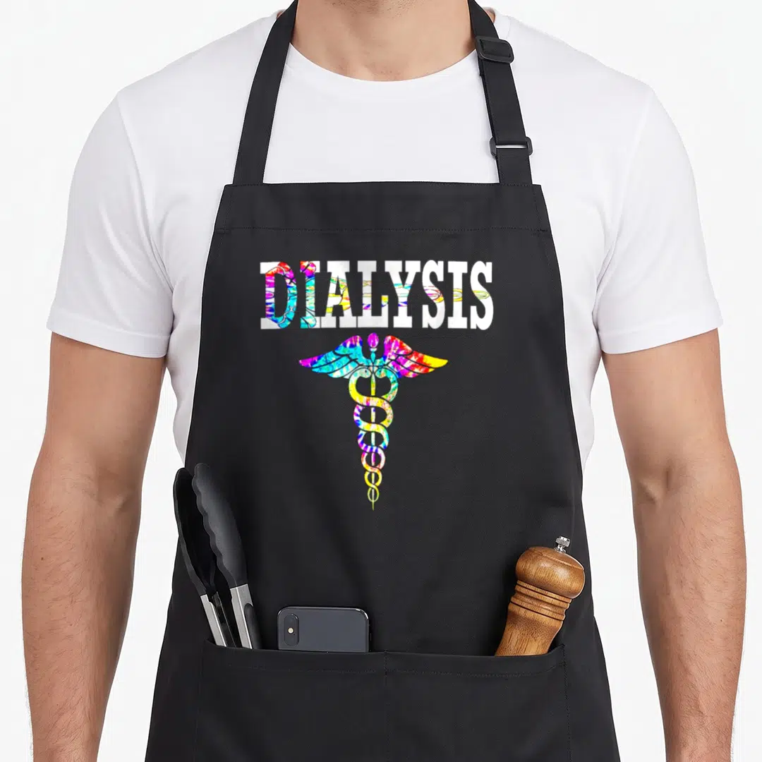 Dialysis technician squad apron - Tie-dye caduceus below DIALYSIS text in blue pink yellow green purple — shown on a black cotton canvas apron against a white background