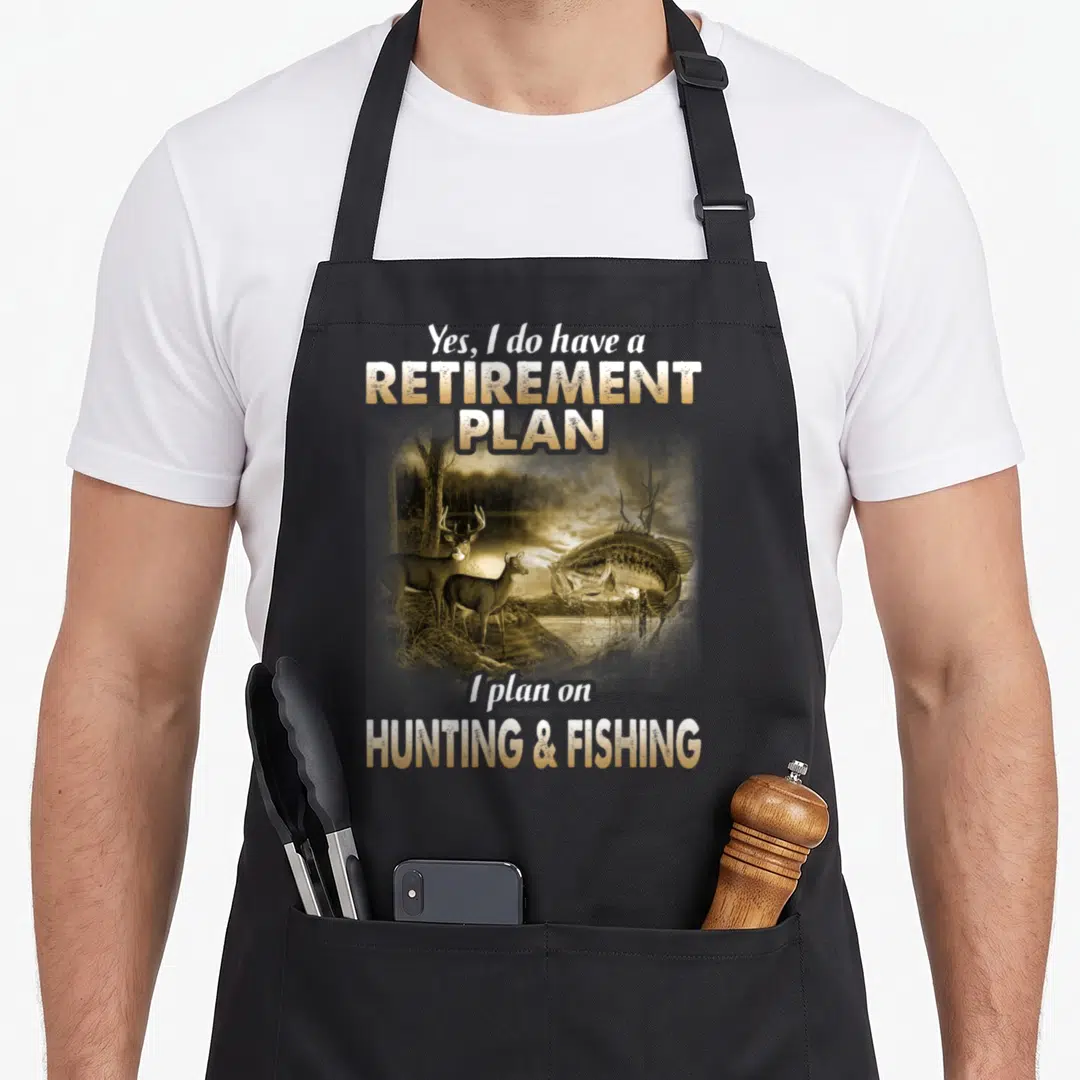 Plan fishing apron - Realistic two deer and leaping fish illustration with retirement plan text — shown on a black cotton canvas apron against a white background