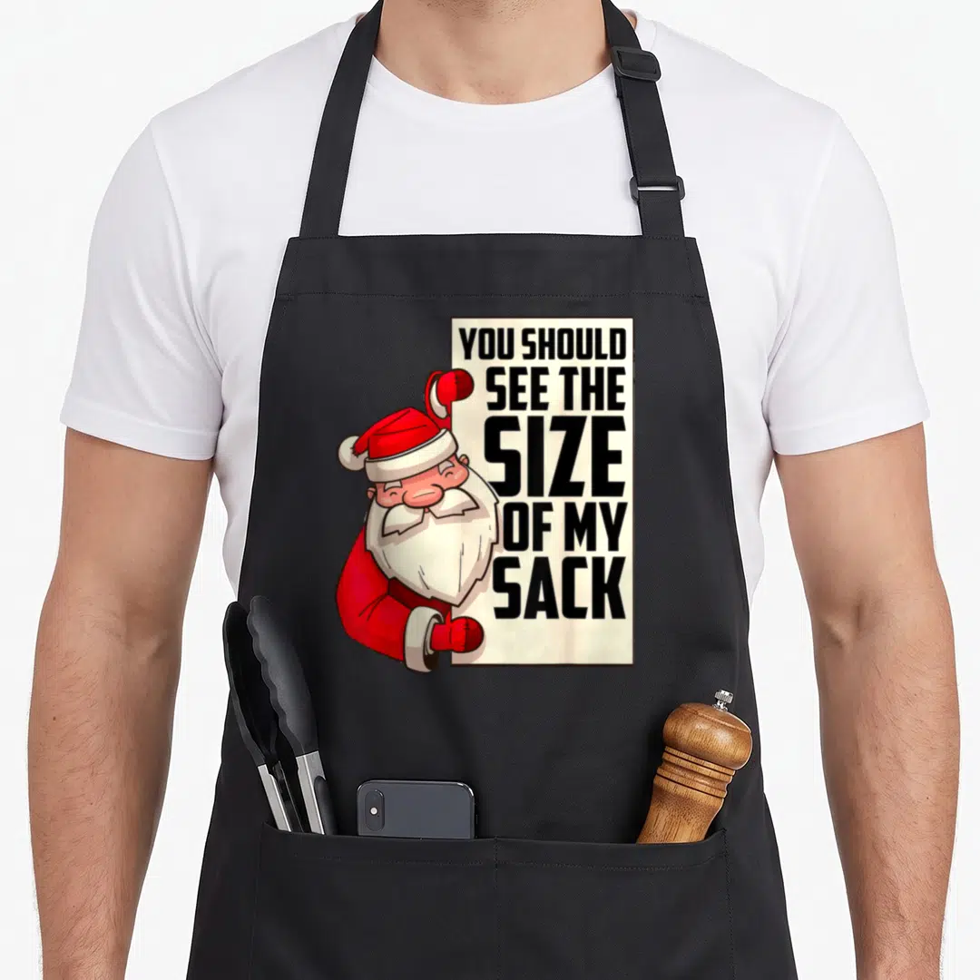 Should santa apron - Santa peeking from behind sign reading YOU SHOULD SEE THE SIZE OF MY SACK — shown on a black cotton canvas apron against a white background