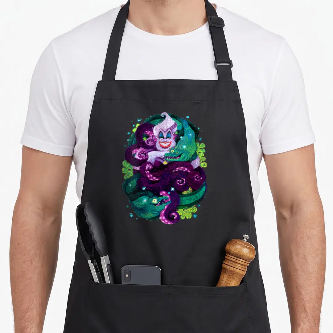 Sea witch apron - Fantasy creature surrounded by purple and green swirling tentacles and serpents in digital art — shown on a black cotton canvas apron against a white background