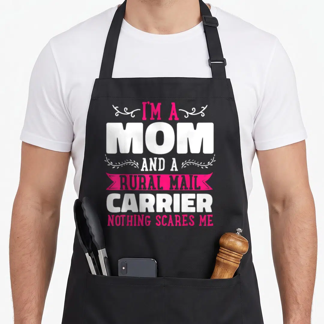 Rural mother's day aprons - I'm a Mom Rural Mail Carrier text with pink ribbon and white swirls — shown on a black cotton canvas apron against a white background