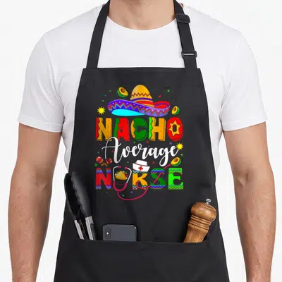 Nurse mexican apron - Colorful Nacho Average NURSE text with sombrero, stethoscope, avocados, and maracas in red yellow — shown on a black cotton canvas apron against a white background