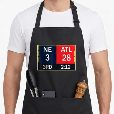 Atl game aprons - Scoreboard graphic showing NE 3 ATL 28 in blue red and yellow blocks — shown on a black cotton canvas apron against a white background