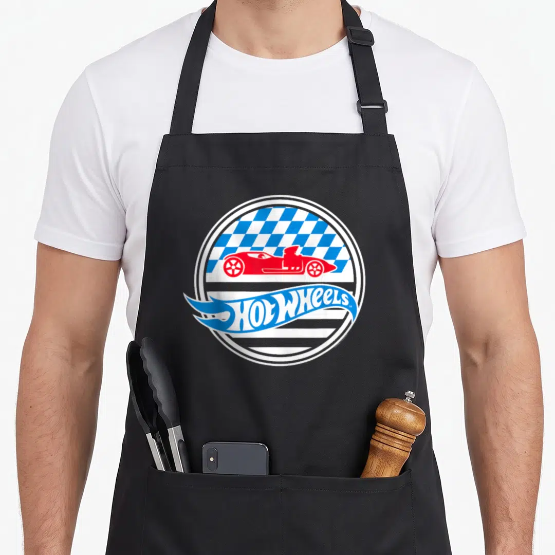Star wheel apron - Red race car over blue and white checkered circle with flame Hot Wheels text logo — shown on a black cotton canvas apron against a white background