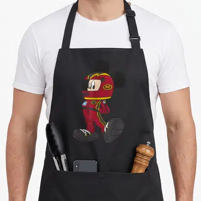 Outfit car apron - Mickey Mouse in red racing suit and helmet with M logo — shown on a black cotton canvas apron against a white background