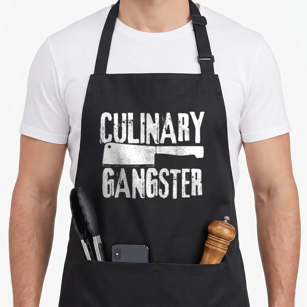 Koch gangster culinary aprons - White distressed cleaver graphic between CULINARY and GANGSTER text — shown on a black cotton canvas apron against a white background