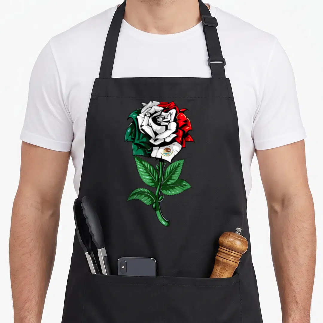 Mexico mexican apron - Rose with green white and red petals and national emblem on stem — shown on a black cotton canvas apron against a white background