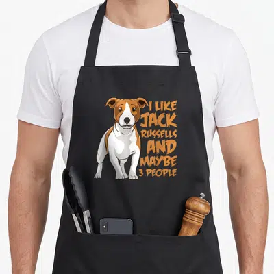 Jack rat pet apron - Cartoon Jack Russell dog next to stacked orange text reading I Like Jack Russells And Maybe 3 — shown on a black cotton canvas apron against a white background