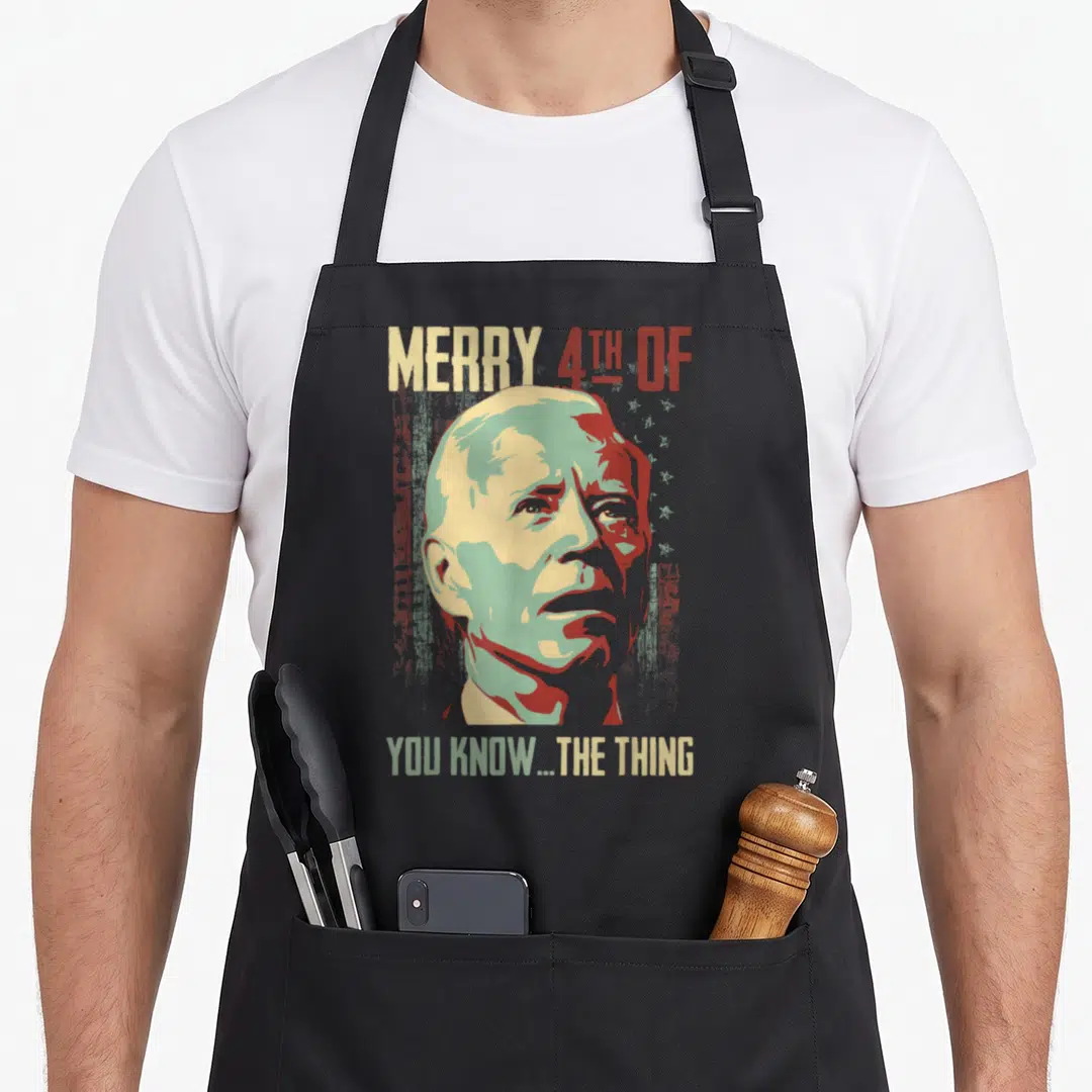 Merry 4th of july apron - Distressed portrait with beige red green text reading Merry 4th Of You Know The Thing — shown on a black cotton canvas apron against a white background