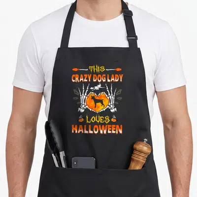 Rat terrier halloween dog apron - Skeleton hands hold orange moon with dog silhouette under This Crazy Dog Lady Loves — shown on a black cotton canvas apron against a white background