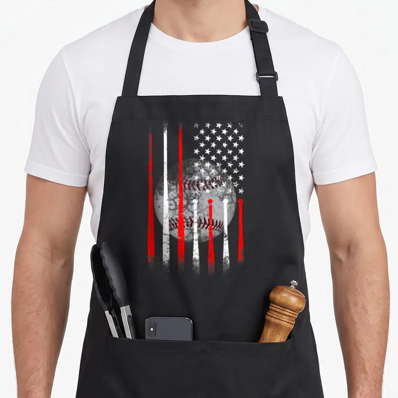 Funny baseball american flag apron - Distressed red and white baseball with flag stripes and stars — shown on a black cotton canvas apron against a white background
