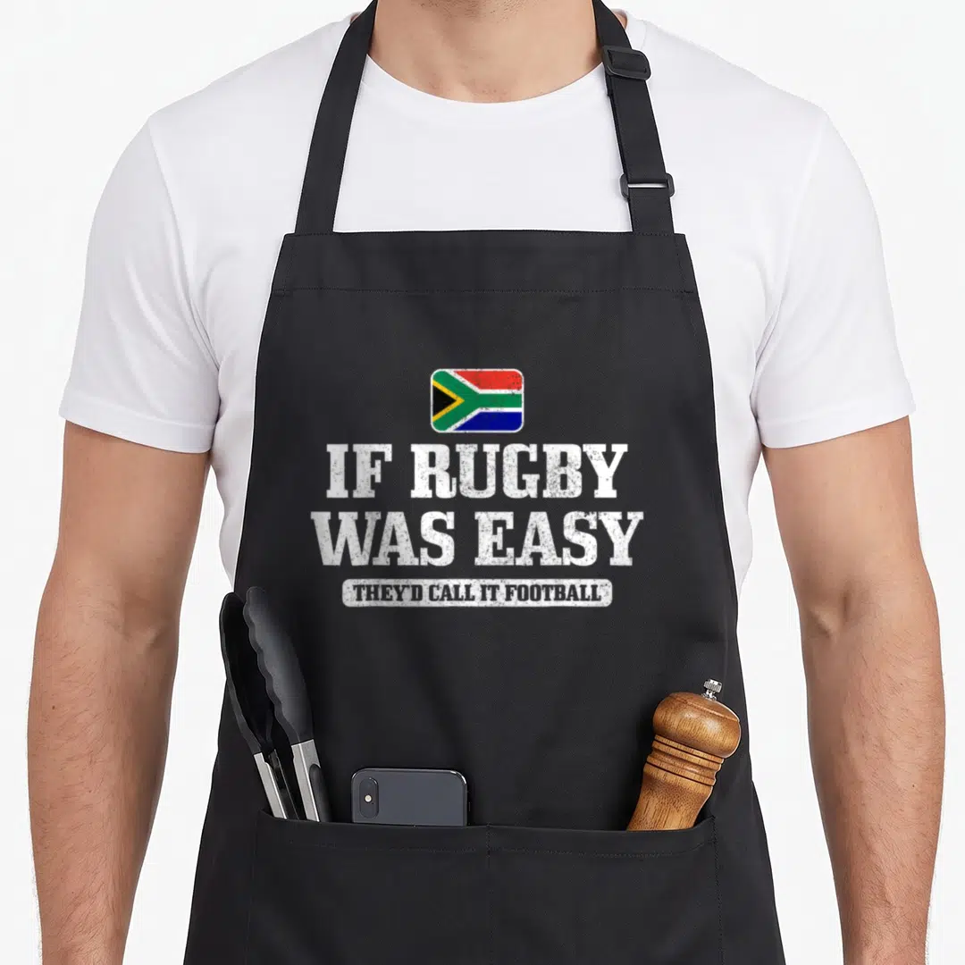 South easy apron - South African flag above distressed text IF RUGBY WAS EASY THEY D CALL IT FOOTBALL — shown on a black cotton canvas apron against a white background