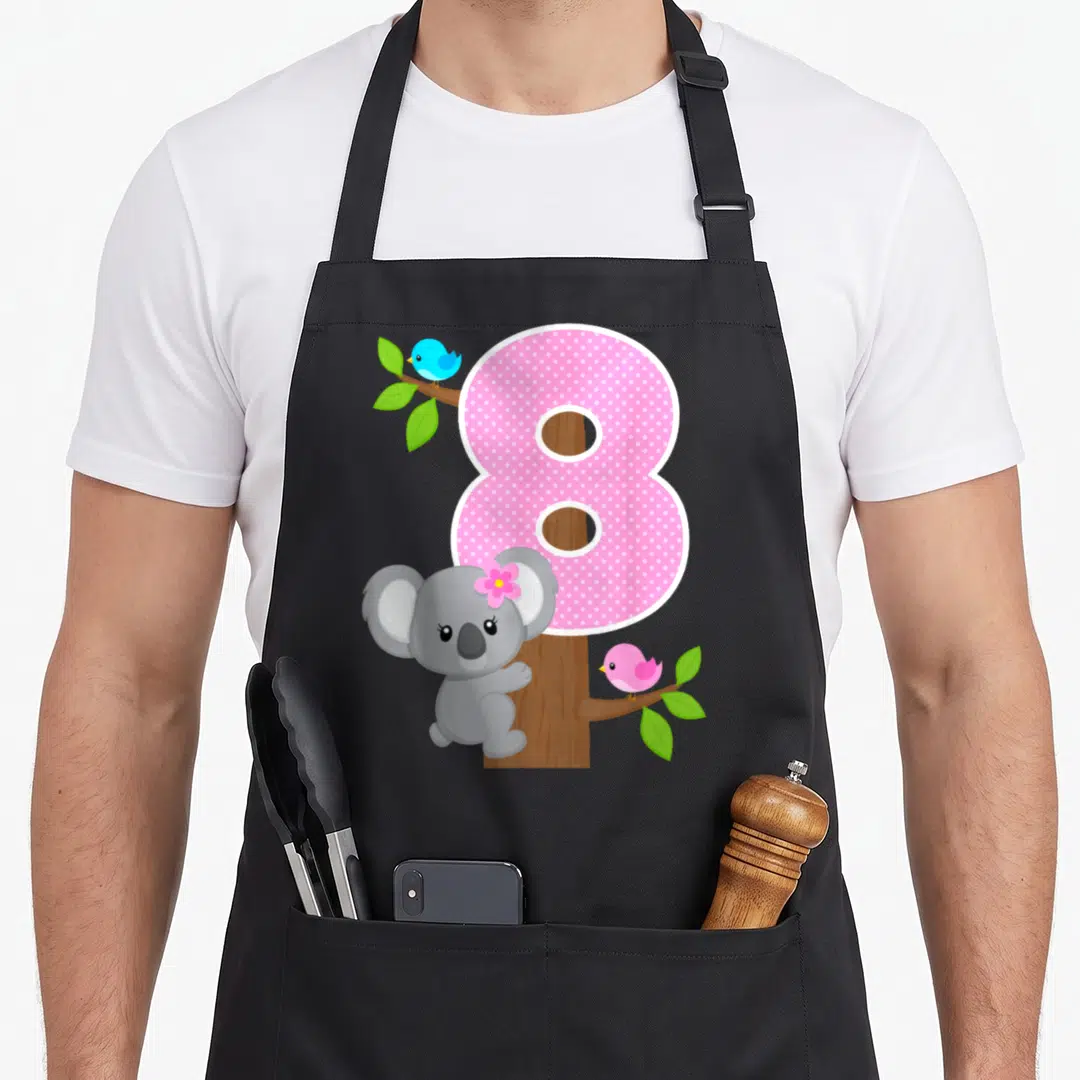 8th bear apron - Pink polka dot number 8 with grey koala and blue and pink birds on tree branches — shown on a black cotton canvas apron against a white background