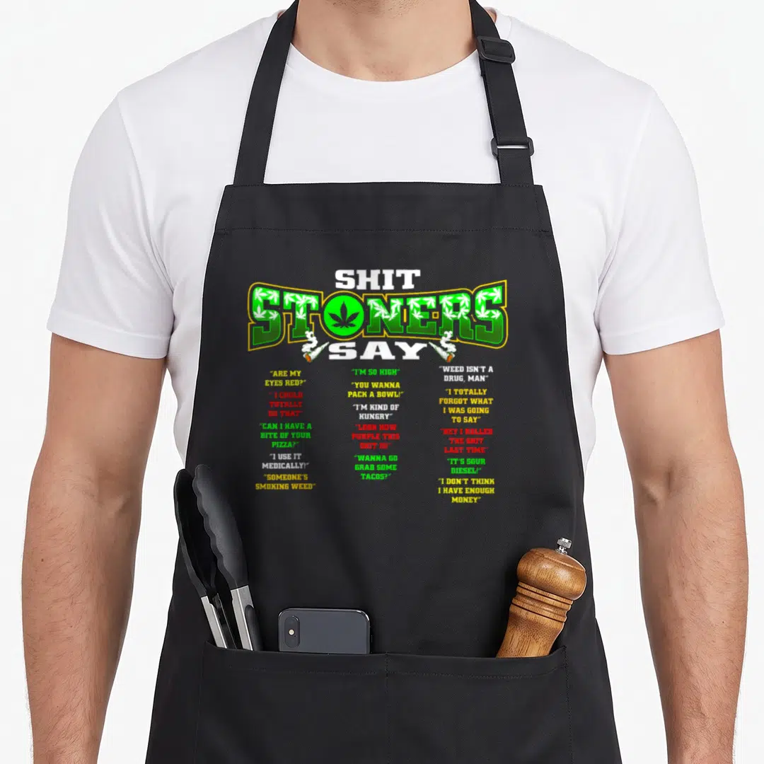 Cannabis smoker apron - Shit Stoners Say text with green leaf pattern and 18 colorful quotes listing stoner dialogue — shown on a black cotton canvas apron against a white background