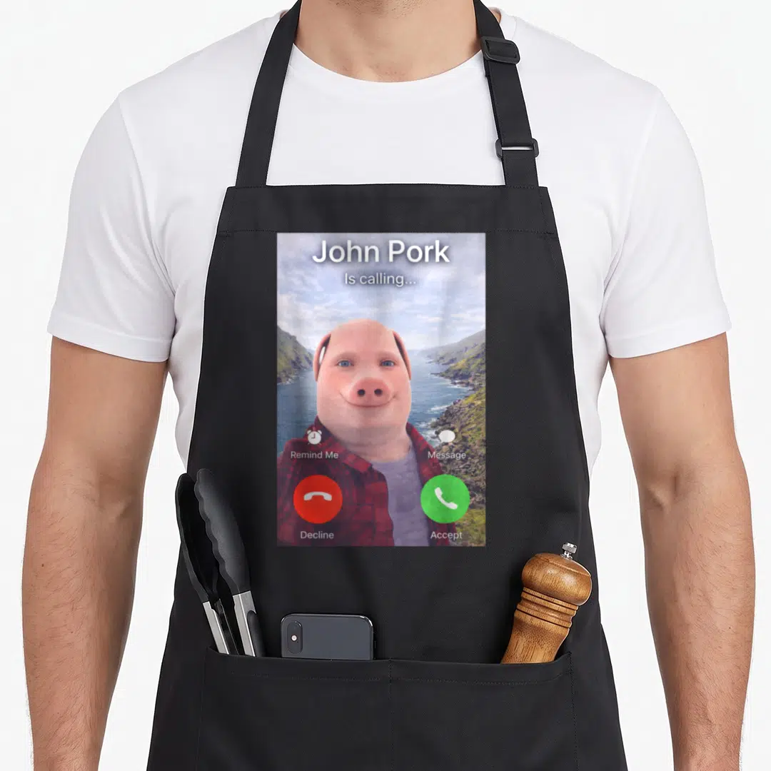 John gag aprons - Pig-human hybrid phone screen with red decline and green accept buttons — shown on a black cotton canvas apron against a white background