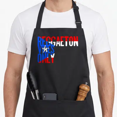 Funny reggaeton apron - Red blue and white stacked text reading REGGAETON VIBES ONLY — shown on a black cotton canvas apron against a white background