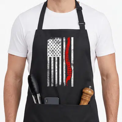 Chiropractor american flag apron - Red spine over distressed white flag layout, no text — shown on a black cotton canvas apron against a white background