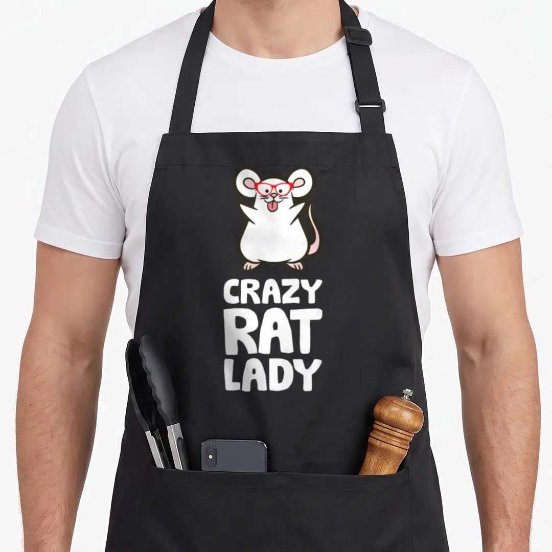 Crazy rat lady apron for the kitchen - Cartoon white rat with red glasses above stacked white text CRAZY RAT LADY — shown on a black cotton canvas apron against a white background