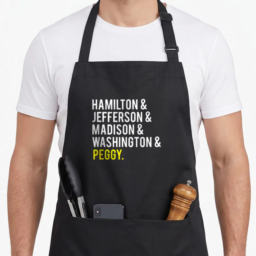 Jefferson hamilton ohio apron - Stacked white and yellow text reading Hamilton Jefferson Madison Washington Peggy — shown on a black cotton canvas apron against a white background