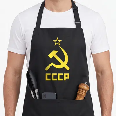 Communist hammer apron - Yellow star, hammer, sickle, and CCCP text on black background — shown on a black cotton canvas apron against a white background