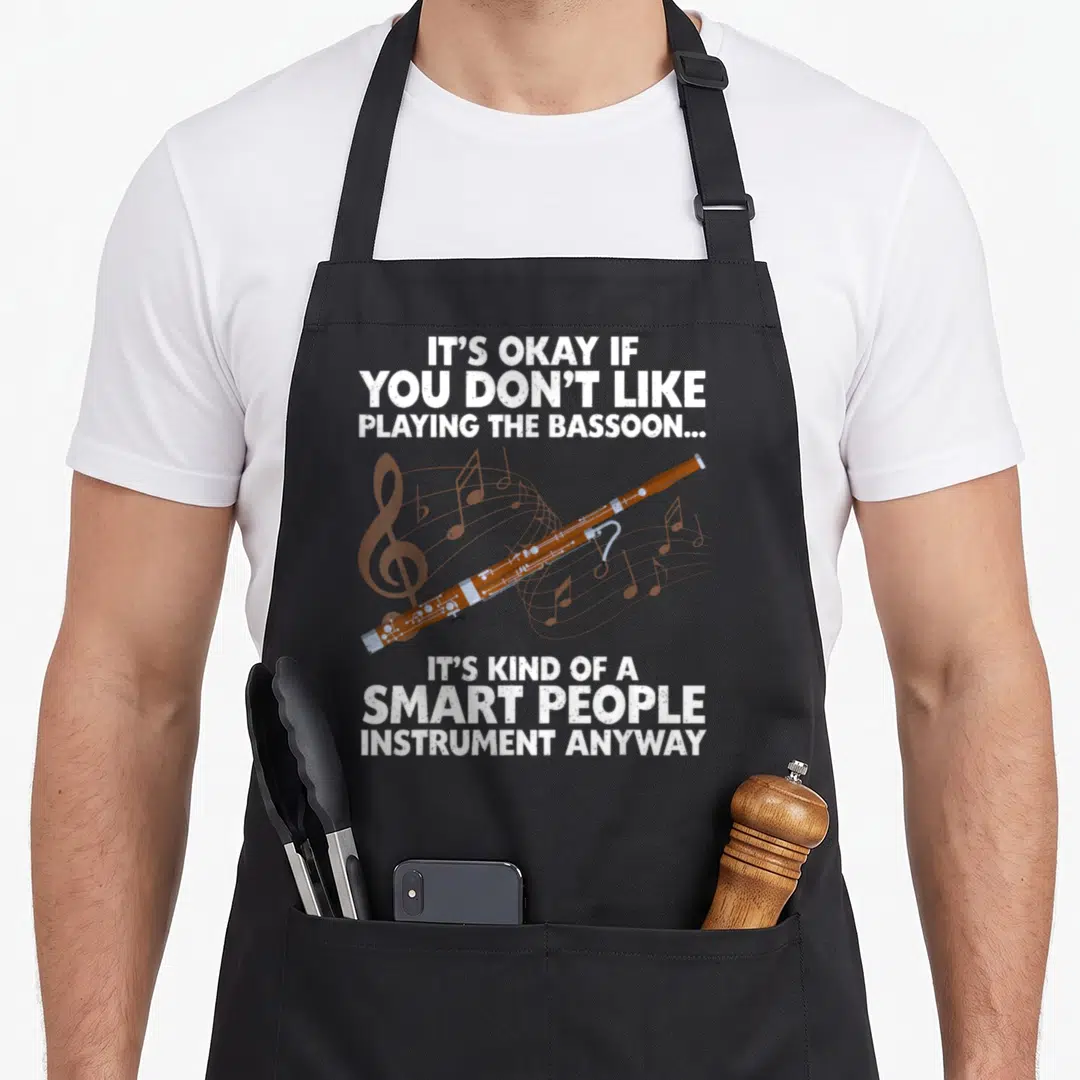 Bassoonist bassoon quotes apron - Brown bassoon and white sarcastic text on distressed background — shown on a black cotton canvas apron against a white background