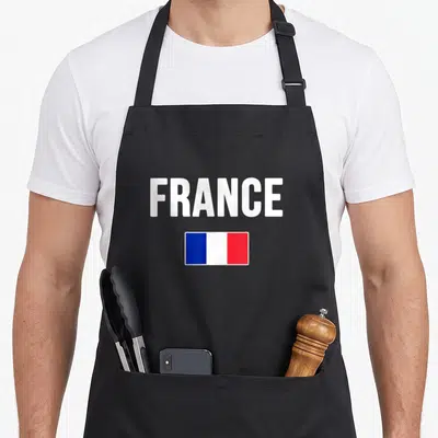 Flag french apron - White FRANCE text above a rectangular blue white and red flag — shown on a black cotton canvas apron against a white background