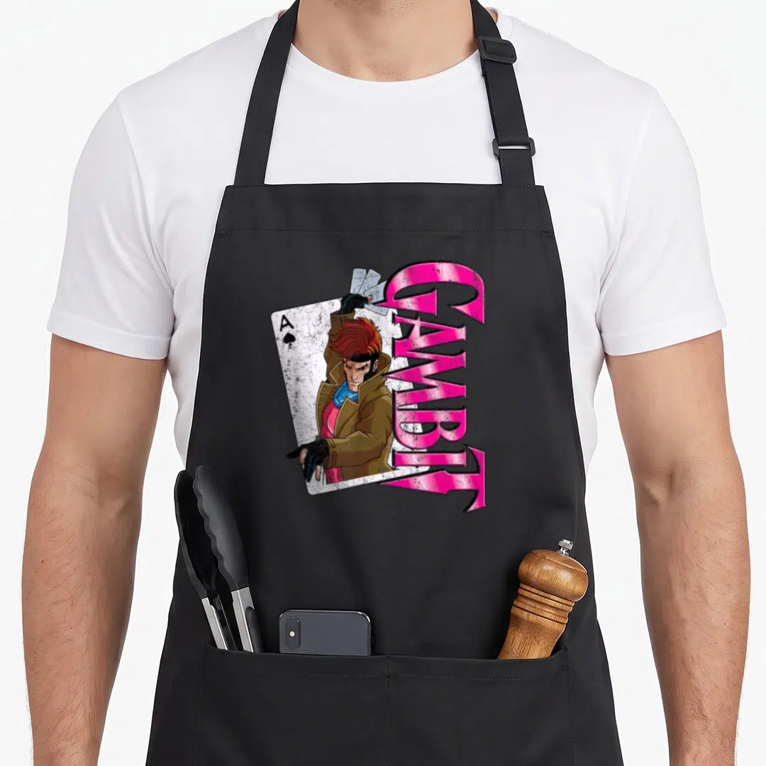 Gambit card x apron - Gambit character with Ace of Spades and vertical pink GAMBIT text — shown on a black cotton canvas apron against a white background