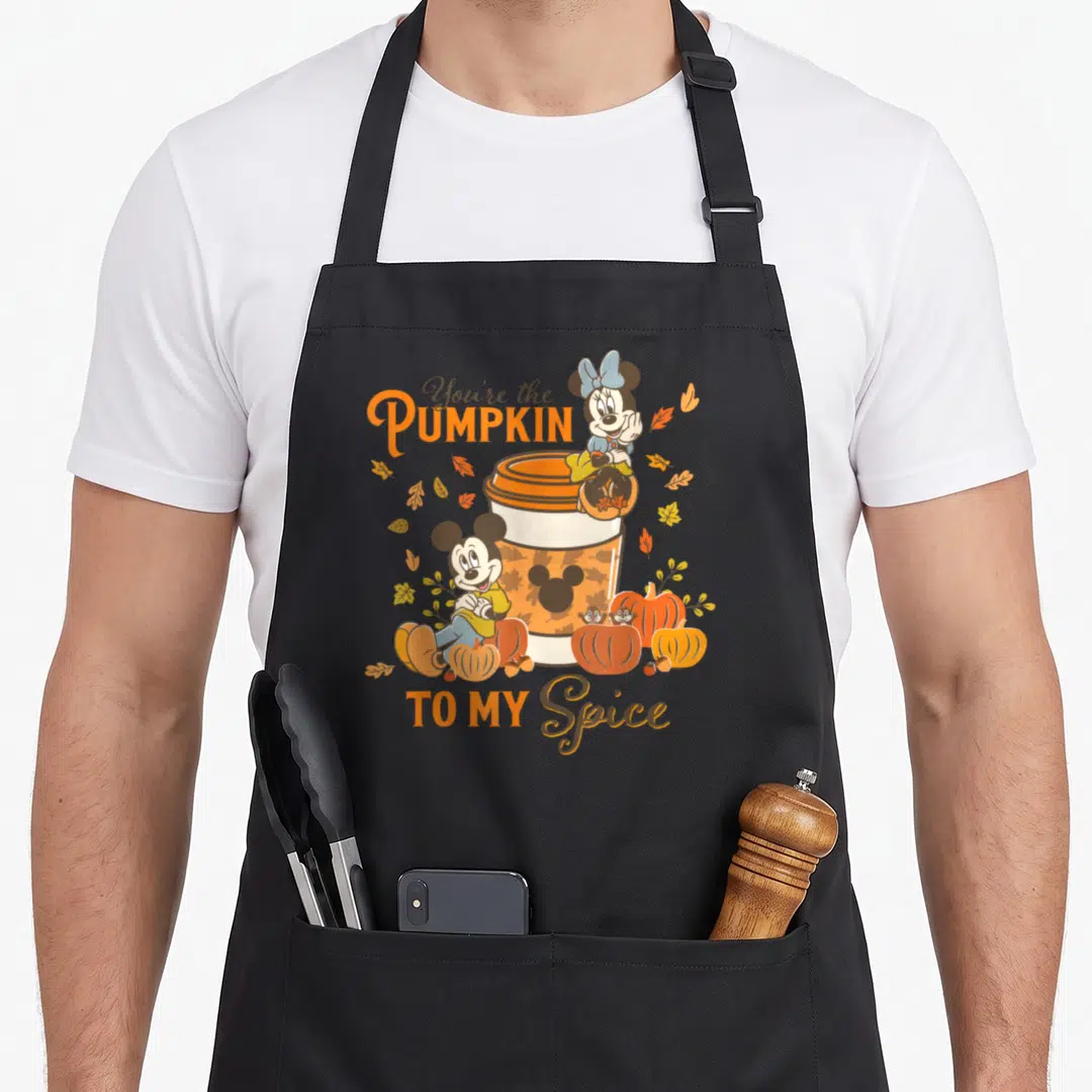 Pumpkin fall spice apron - Mickey Minnie on coffee cup with pumpkins leaves and You're the Pumpkin TO MY Spice text — shown on a black cotton canvas apron against a white background