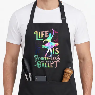 Less ballerina apron - Rainbow striped text LIFE IS POINTE-LESS WITHOUT BALLET around watercolor dancer silhouette — shown on a black cotton canvas apron against a white background