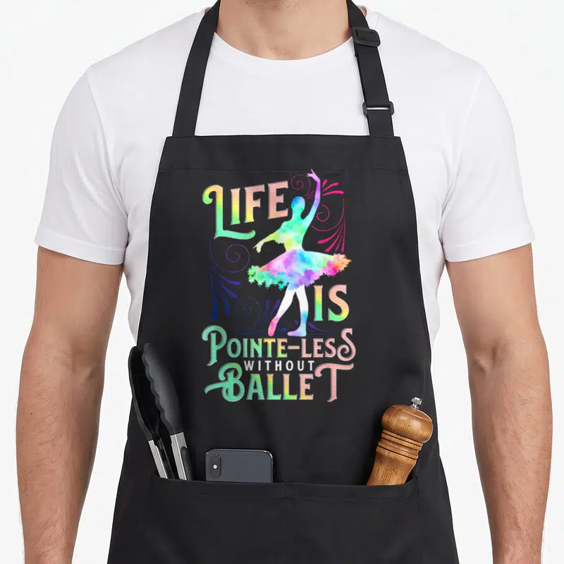 Less ballerina apron - Rainbow striped text LIFE IS POINTE-LESS WITHOUT BALLET around watercolor dancer silhouette — shown on a black cotton canvas apron against a white background