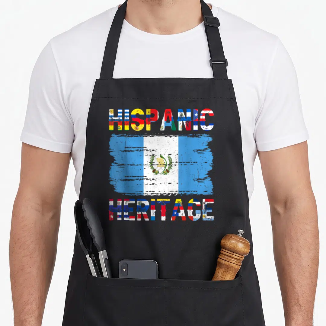 Hispanic guatemalan aprons - HISPANIC HERITAGE text framing a distressed Guatemalan flag with multi-colored letter fills — shown on a black cotton canvas apron against a white background