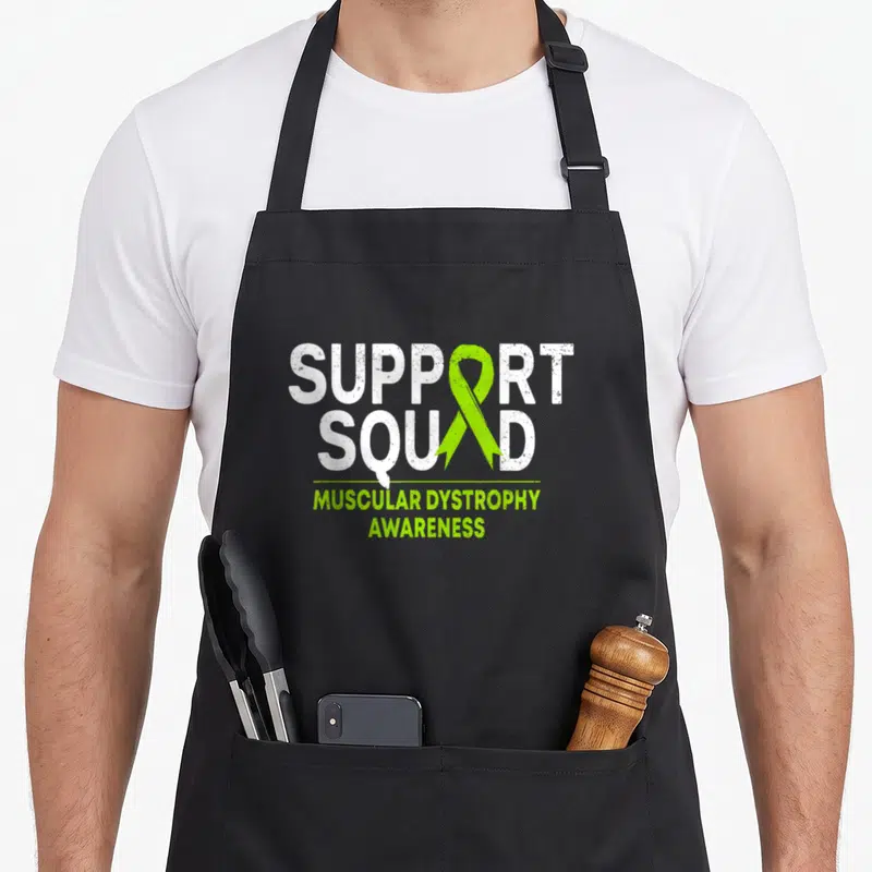 Dystrophy ribbon apron - Distressed white Support Squad text with vertical lime green ribbon and Muscular Dystrophy — shown on a black cotton canvas apron against a white background