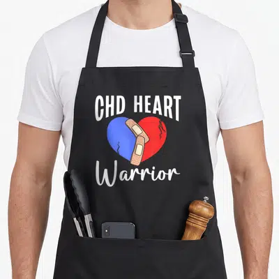 Chd warrior congenital heart defect apron - Cracked blue red heart with two bandages and CHD HEART Warrior text — shown on a black cotton canvas apron against a white background