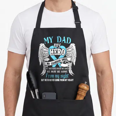 Hero guardian angels and aprons - My Dad my Hero text with blue ribbon, white wings, and guardian angel banner — shown on a black cotton canvas apron against a white background