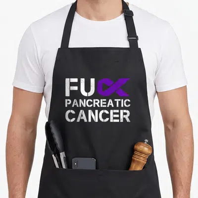 Pancreatic ribbon apron - White distressed text with purple ribbon replacing letter K on black background — shown on a black cotton canvas apron against a white background