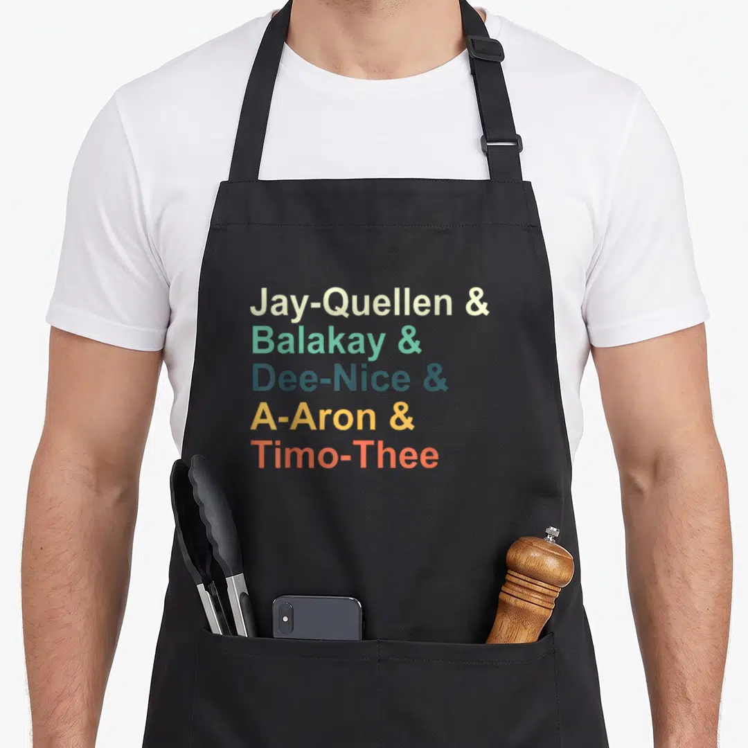 Quellen jay mom apron - Stacked colorful text reading Jay-Quellen Balakay Dee-Nice A-Aron Timo-Thee on black fabric — shown on a black cotton canvas apron against a white background