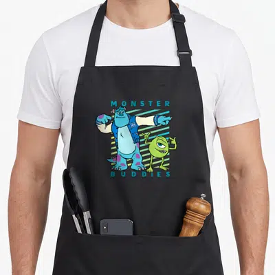 Sulley buddy aprons - Two monsters with MONSTER BUDDIES text and blue green teal diagonal stripes — shown on a black cotton canvas apron against a white background