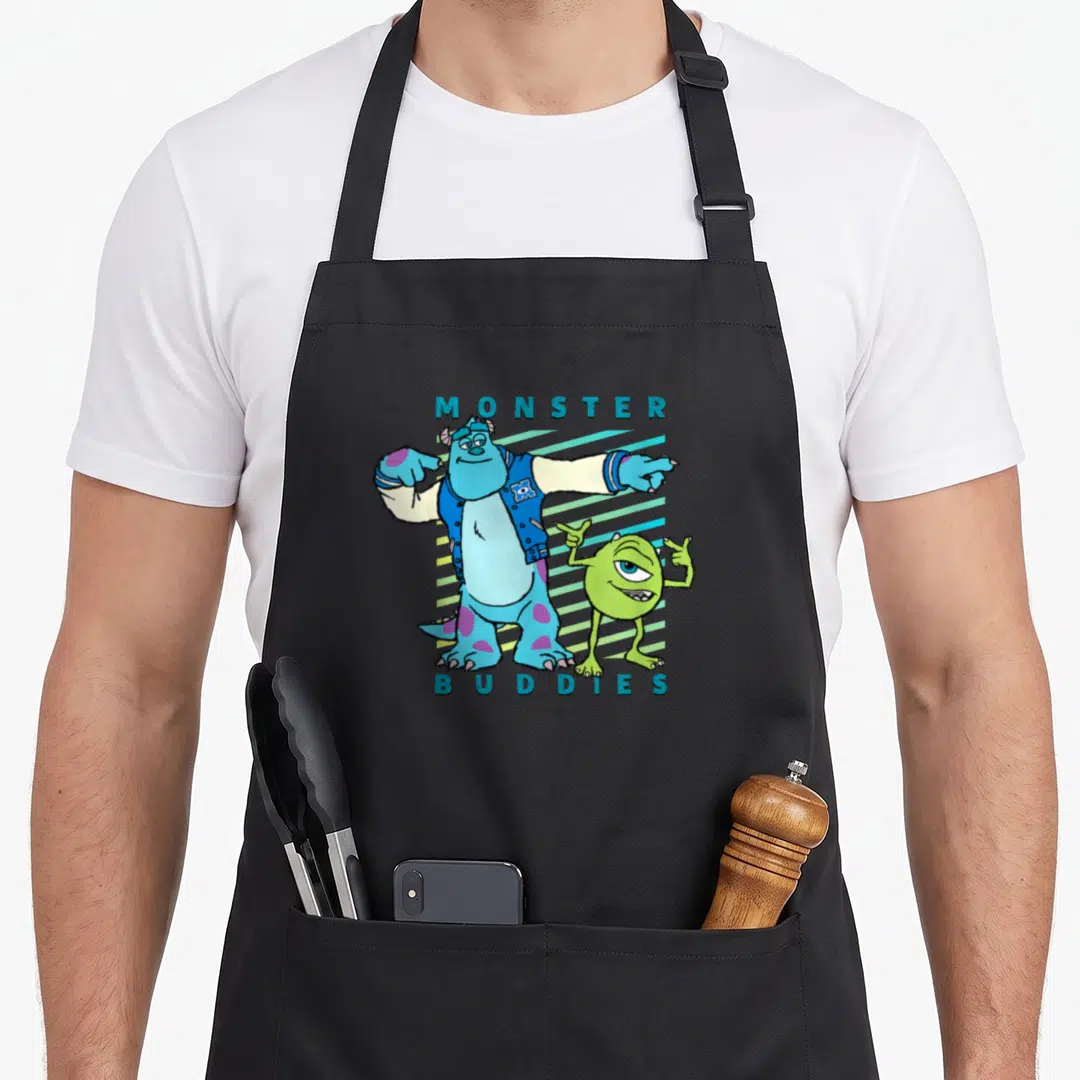 Sulley buddy aprons - Two monsters with MONSTER BUDDIES text and blue green teal diagonal stripes — shown on a black cotton canvas apron against a white background