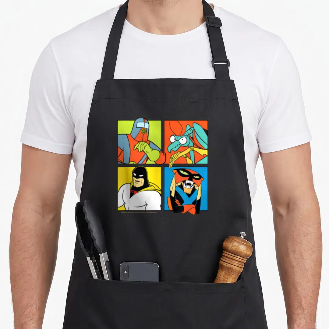 Hero ghost apron - Four cartoon characters in red blue yellow green orange squares grid — shown on a black cotton canvas apron against a white background