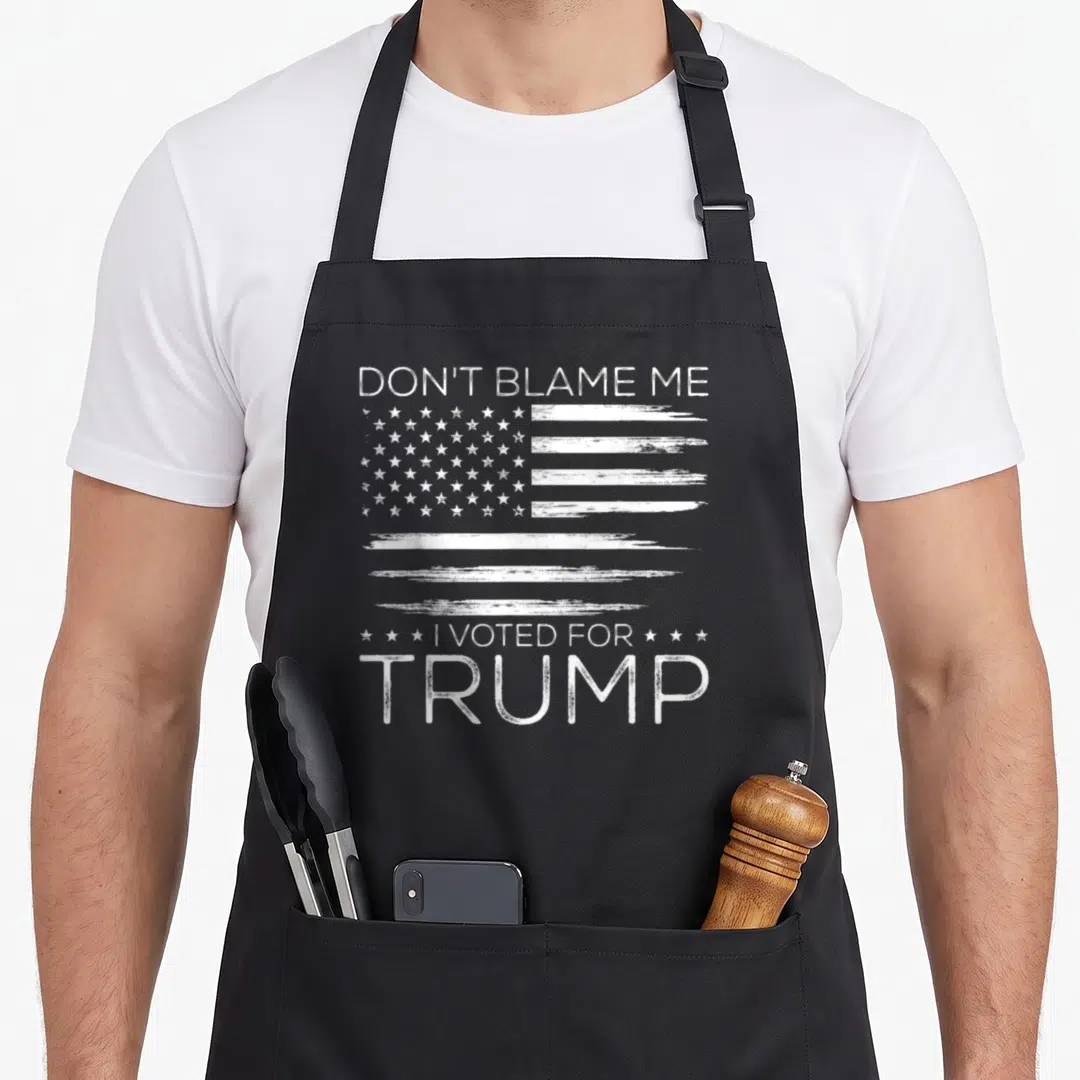 Blame american flag apron - White distressed USA flag with Don't Blame Me I Voted For Trump text — shown on a black cotton canvas apron against a white background