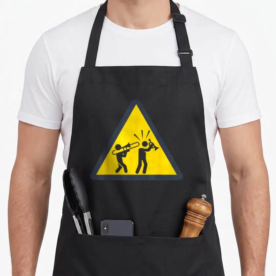 Trombonist trombone apron - Yellow warning sign with two grey stick figures playing trombone and trumpet — shown on a black cotton canvas apron against a white background