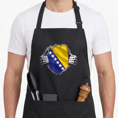 Flag bosnian girl apron - Hands tearing grey surface to reveal blue yellow and white Bosnia flag with white stars — shown on a black cotton canvas apron against a white background