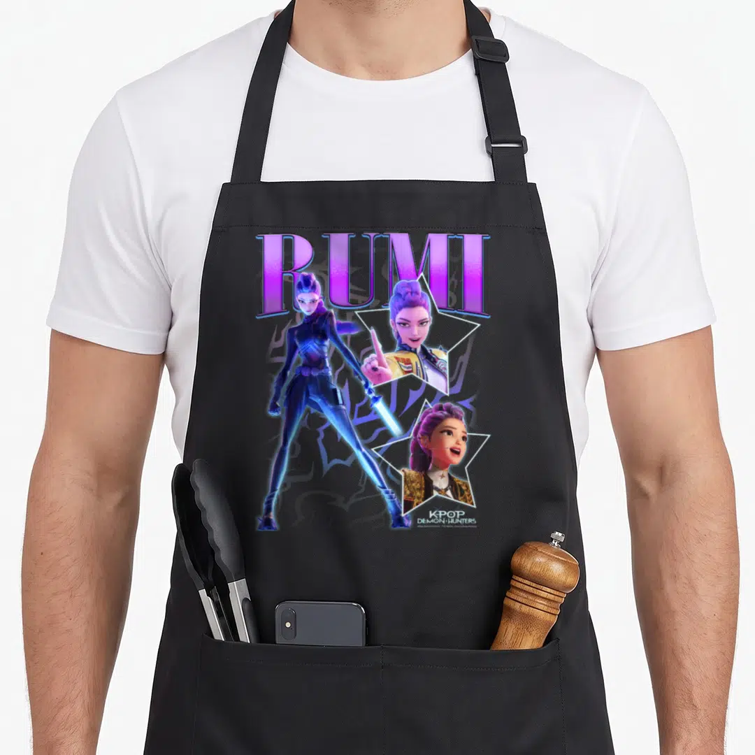 Rumi hunting hunter apron - Rumi character art with purple text, blue full-body figure, and two star-framed headshots — shown on a black cotton canvas apron against a white background