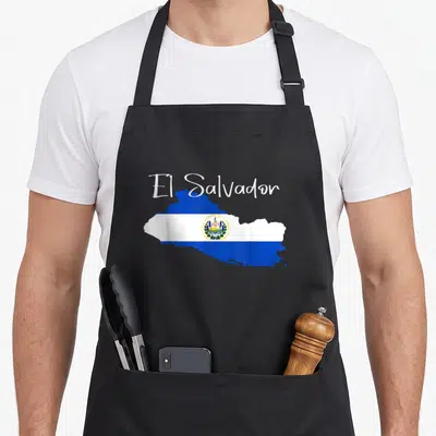 Map el cook apron - Map of El Salvador filled with blue and white flag stripes and central emblem, text above — shown on a black cotton canvas apron against a white background