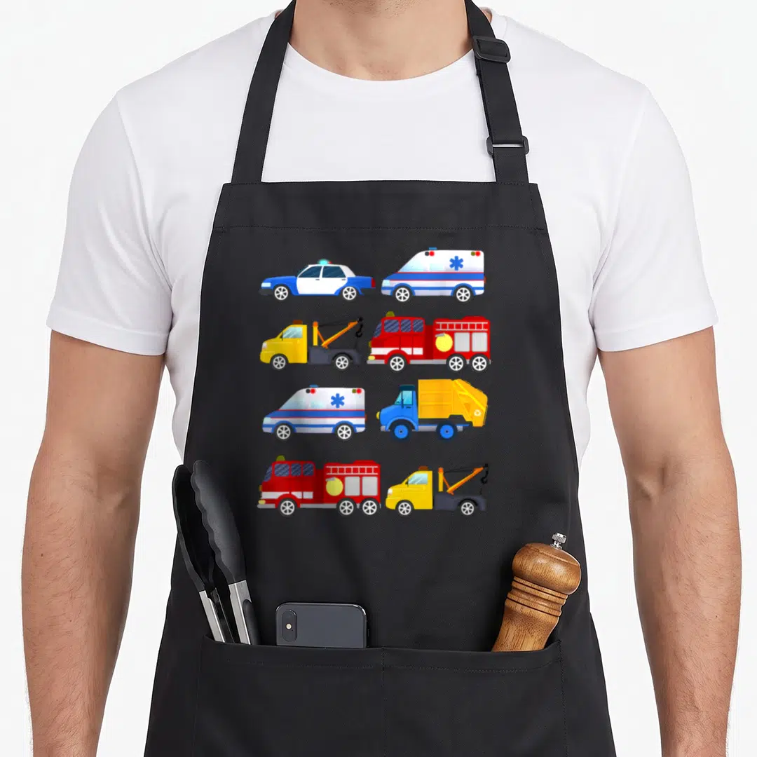 Emergency vehicle truck apron - Eight cartoon rescue vehicles including fire trucks and ambulances in red blue — shown on a black cotton canvas apron against a white background
